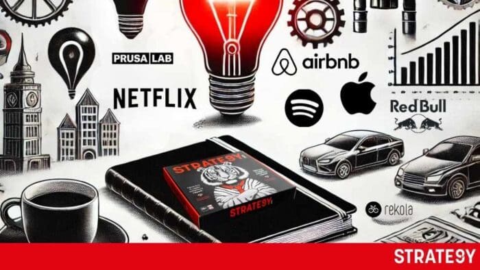 a black box with a red light bulb and a book